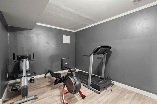 1709 Grove Ct SE, Conyers, GA 30013 - workout room featuring wood finished floors, baseboards, and crown molding