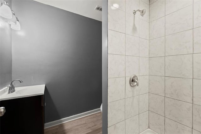 1709 Grove Ct SE, Conyers, GA 30013 - bathroom with vanity, a shower, wood finished floors, and baseboards