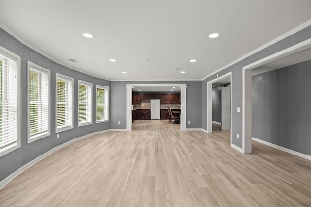 1709 Grove Ct SE, Conyers, GA 30013 - unfurnished living room with ornamental molding, recessed lighting, baseboards, and light wood-type flooring