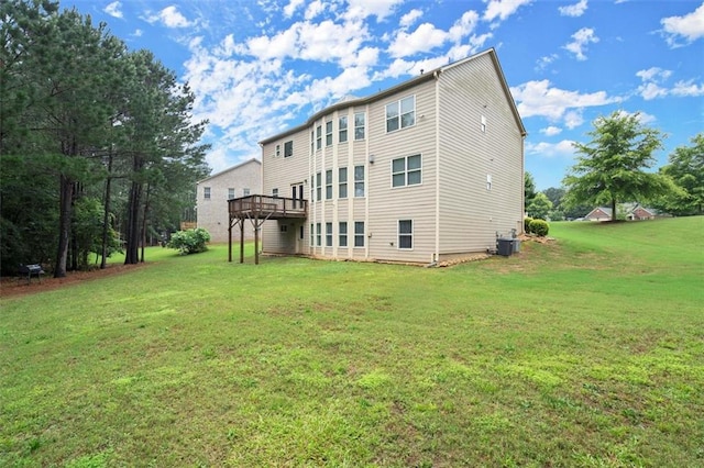 1709 Grove Ct SE, Conyers, GA 30013 - back of house with central air condition unit, a yard, and a deck