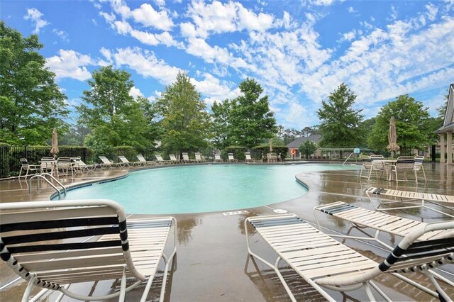 1709 Grove Ct SE, Conyers, GA 30013 - community pool featuring a patio area