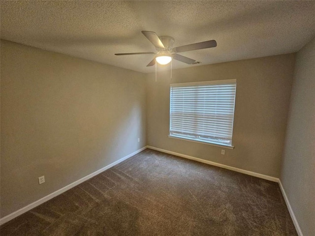 carpeted spare room featuring a textured ceiling and ceiling fan