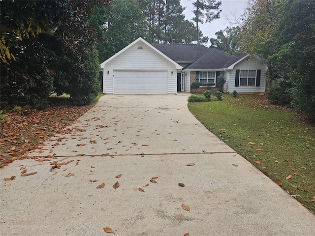 view of front of house with a garage and a front lawn