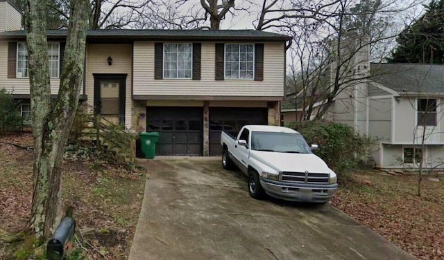 split foyer home featuring driveway and an attached garage