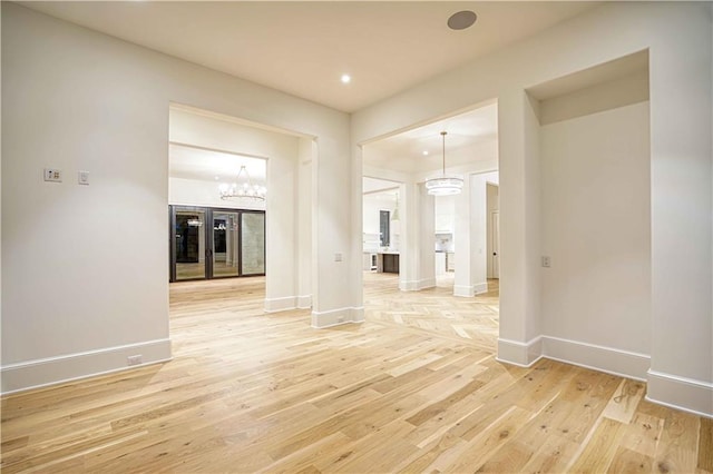 interior space with light wood-type flooring and a notable chandelier