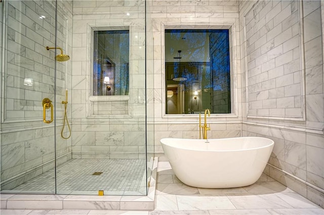 bathroom featuring separate shower and tub and tile walls