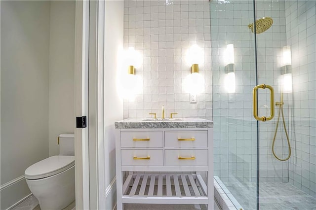 bathroom with an enclosed shower, vanity, and toilet