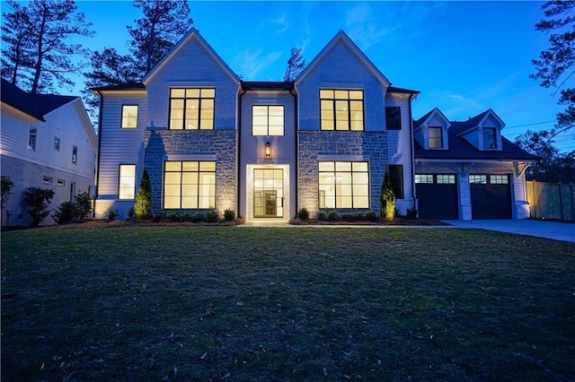 view of front facade featuring a lawn and a garage