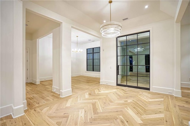 interior space with a chandelier and light parquet floors