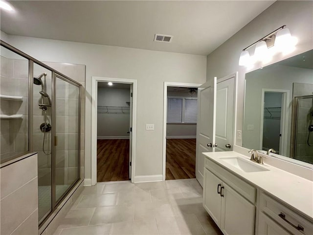 bathroom featuring vanity, tile patterned floors, and a shower with door