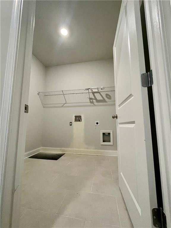 washroom with light tile patterned floors, hookup for a washing machine, and hookup for an electric dryer