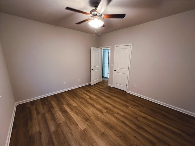 unfurnished bedroom featuring dark wood-type flooring and ceiling fan