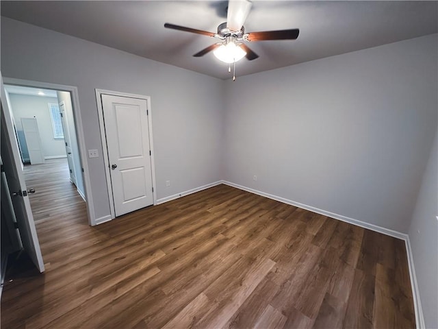 empty room featuring dark hardwood / wood-style floors and ceiling fan