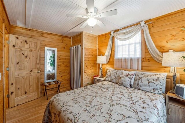 65 Bear Mountain Trl, Cleveland, GA 30528 - bedroom featuring wood walls, a ceiling fan, and wood finished floors