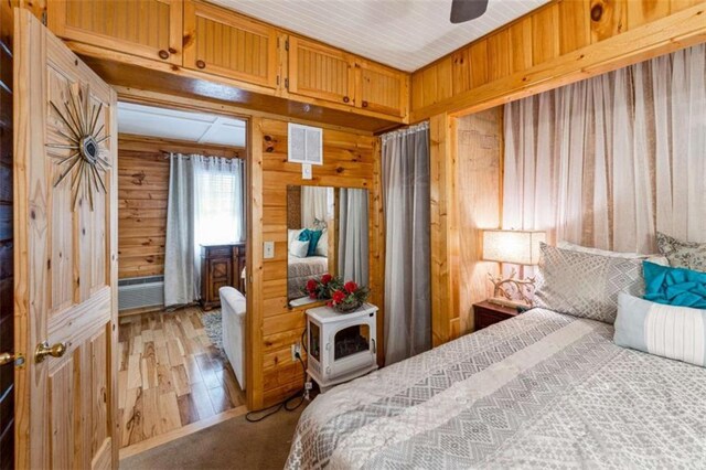 65 Bear Mountain Trl, Cleveland, GA 30528 - bedroom featuring wooden walls, light wood-style floors, and visible vents