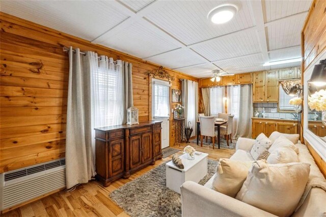 65 Bear Mountain Trl, Cleveland, GA 30528 - living room featuring light wood-type flooring, coffered ceiling, wood walls, and a ceiling fan