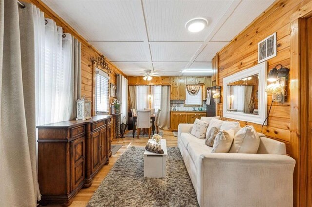 65 Bear Mountain Trl, Cleveland, GA 30528 - living room featuring wooden walls, light wood-style floors, visible vents, and coffered ceiling