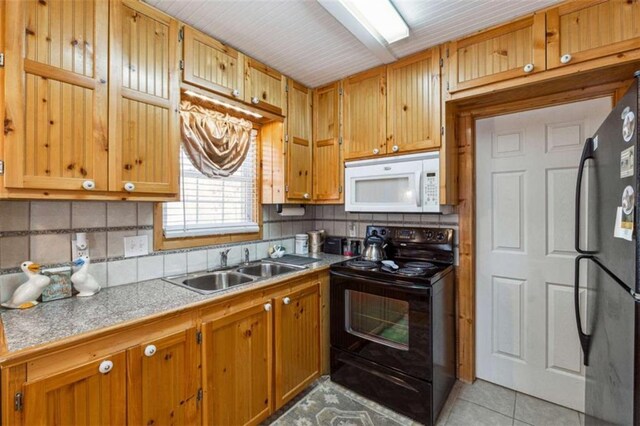 65 Bear Mountain Trl, Cleveland, GA 30528 - kitchen with brown cabinets, black appliances, a sink, backsplash, and light tile patterned floors