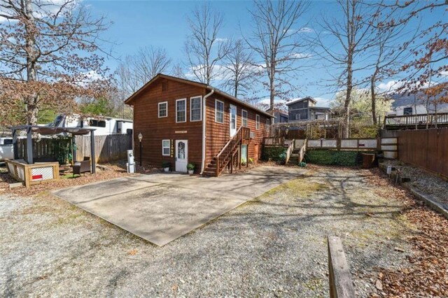 65 Bear Mountain Trl, Cleveland, GA 30528 - back of property with driveway, a pergola, and fence
