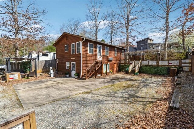 65 Bear Mountain Trl, Cleveland, GA 30528 - rear view of house with stairway, gravel driveway, and fence