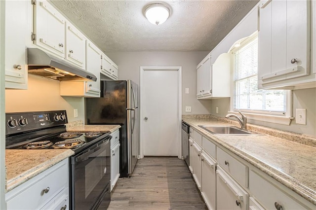 kitchen with white cabinets, black appliances, and a textured ceiling