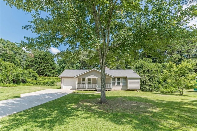 view of front of property featuring a garage, a porch, and a front yard