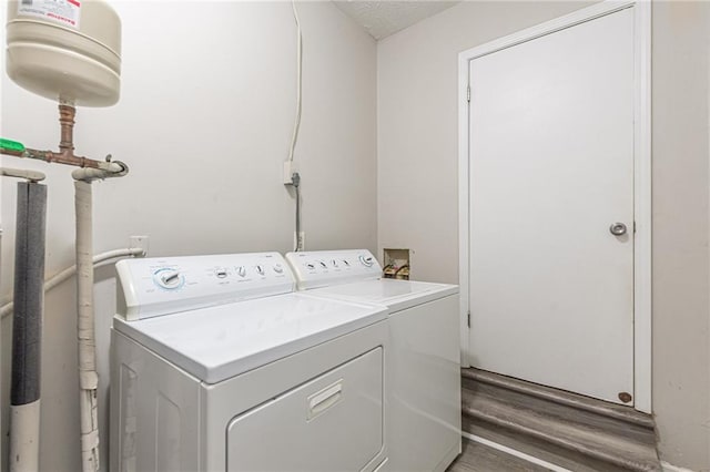 washroom with dark hardwood / wood-style flooring and separate washer and dryer