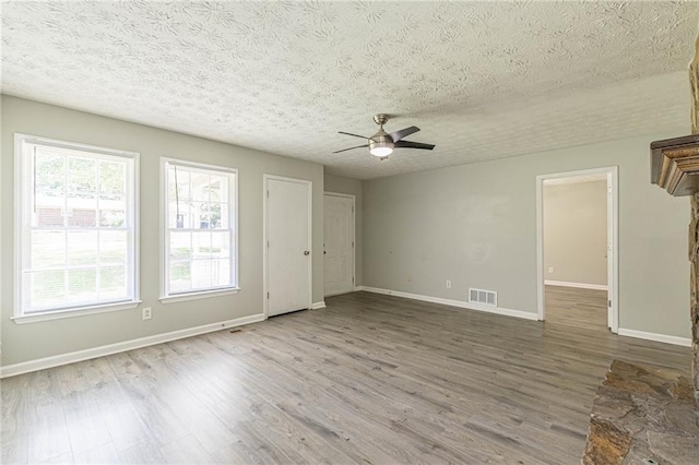 spare room featuring ceiling fan, a textured ceiling, and hardwood / wood-style flooring