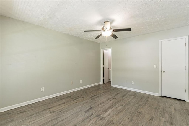 spare room featuring a textured ceiling, dark hardwood / wood-style flooring, and ceiling fan