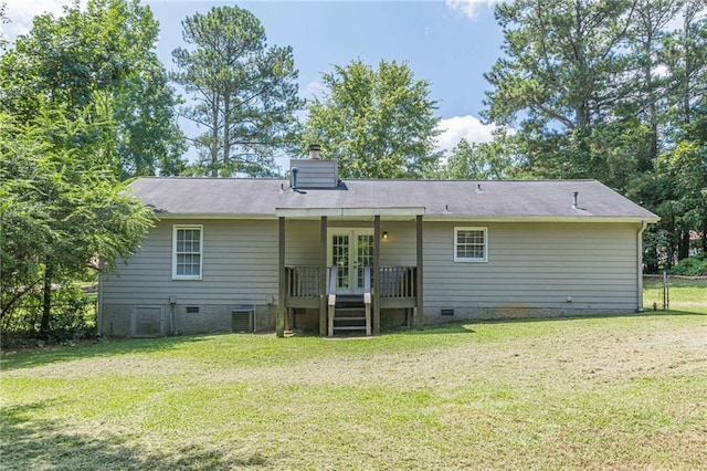 rear view of property featuring a yard, french doors, and central AC