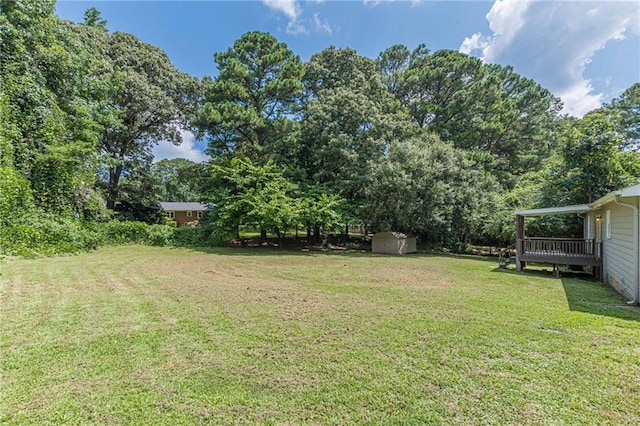 view of yard featuring a shed and a deck