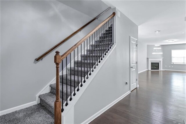 staircase featuring hardwood / wood-style flooring