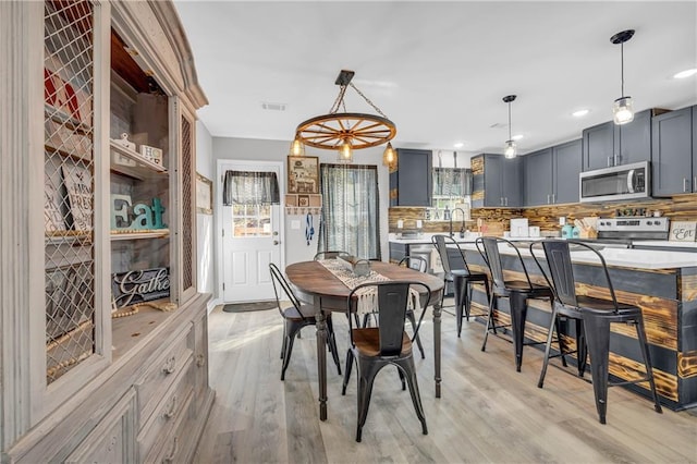 dining area with a wealth of natural light and light hardwood / wood-style floors