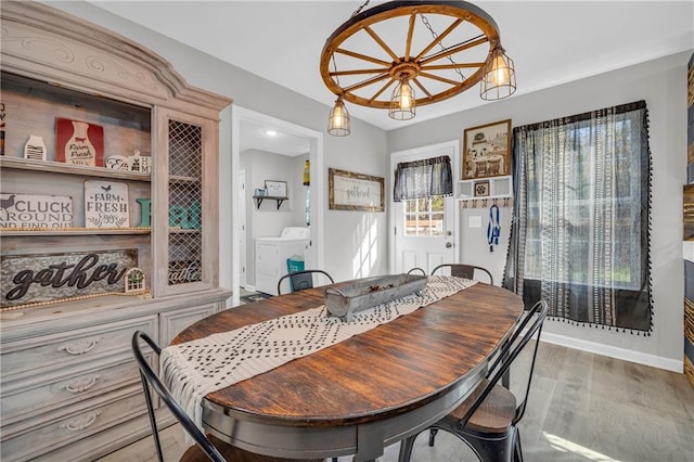 dining room featuring light hardwood / wood-style floors and washer and dryer