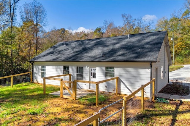 rear view of house featuring a lawn