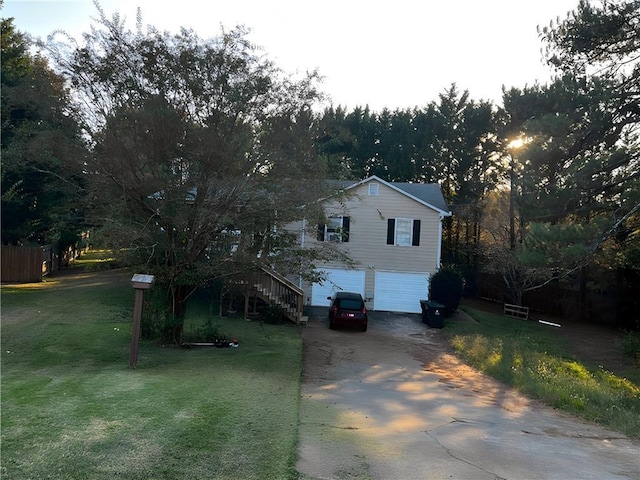 view of front of property featuring a garage and a front lawn