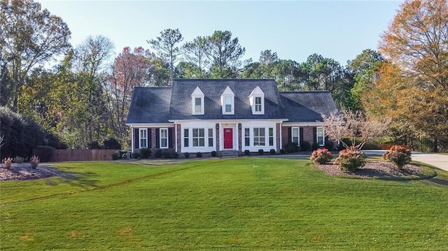 cape cod-style house featuring a front lawn