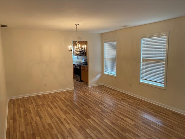 interior space featuring hardwood / wood-style floors and a chandelier