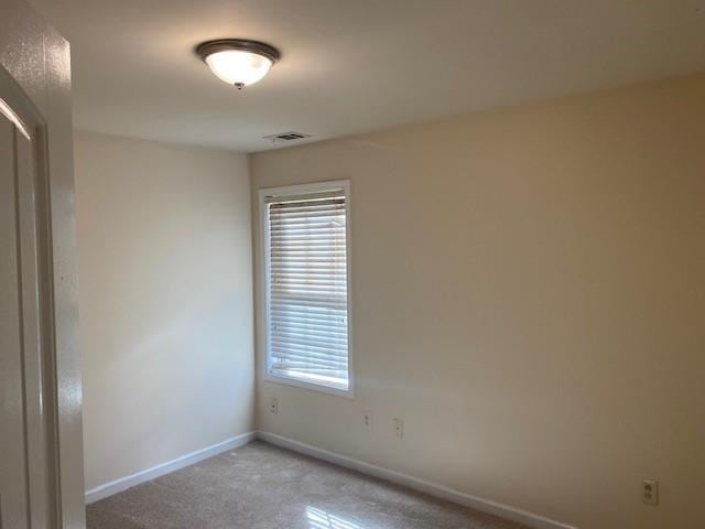 unfurnished room with light colored carpet