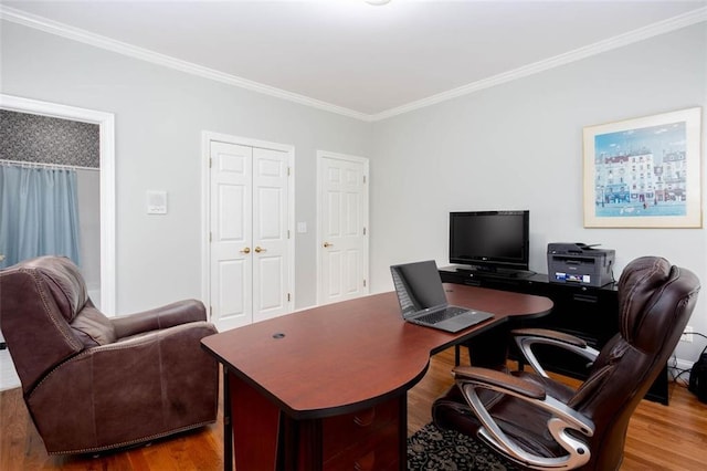 office space with wood finished floors and crown molding