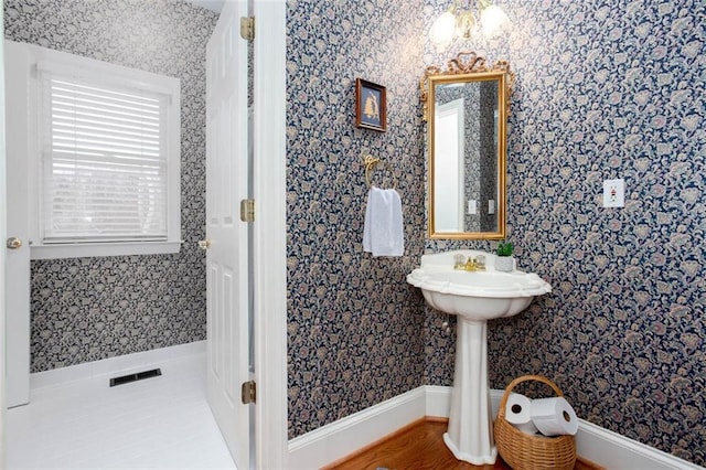 bathroom featuring wallpapered walls and visible vents