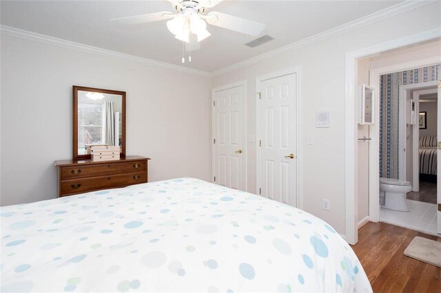 bedroom featuring visible vents, crown molding, ceiling fan, and wood finished floors