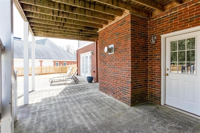 view of patio / terrace featuring french doors and fence