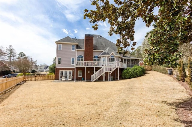 back of property featuring stairs, a sunroom, french doors, a deck, and a fenced backyard