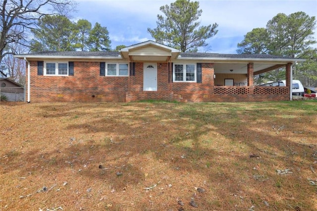 ranch-style house featuring a front lawn and brick siding