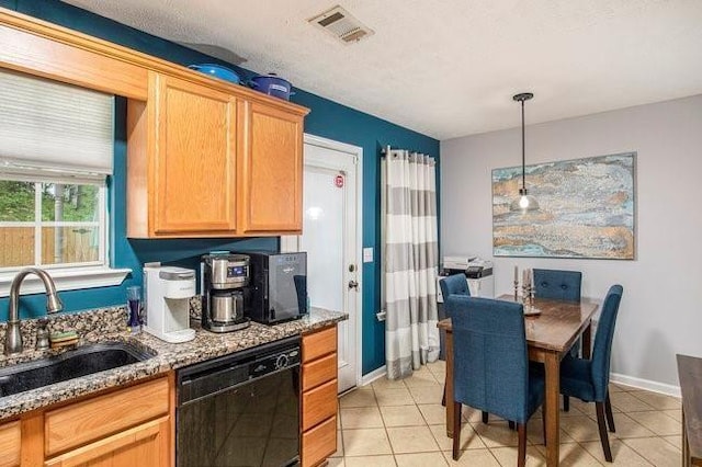 kitchen featuring hanging light fixtures, light tile patterned floors, sink, dishwasher, and light stone countertops