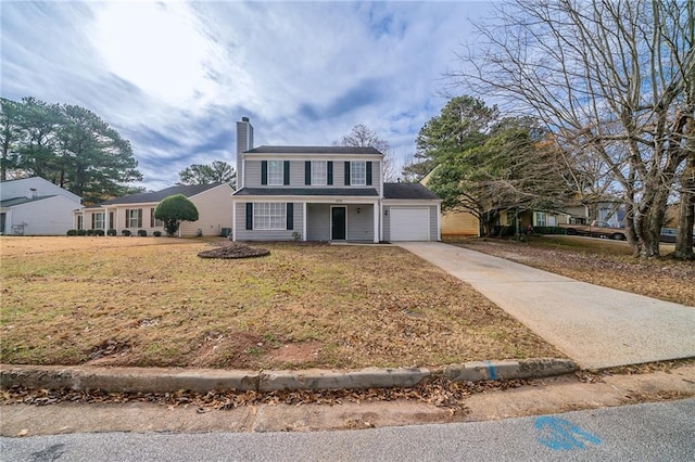 view of property featuring a garage and a front yard