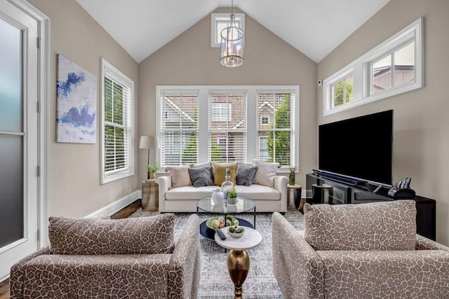 1120 Cordia Ave NW, Atlanta, GA 30318 - living area featuring baseboards, wood finished floors, and high vaulted ceiling