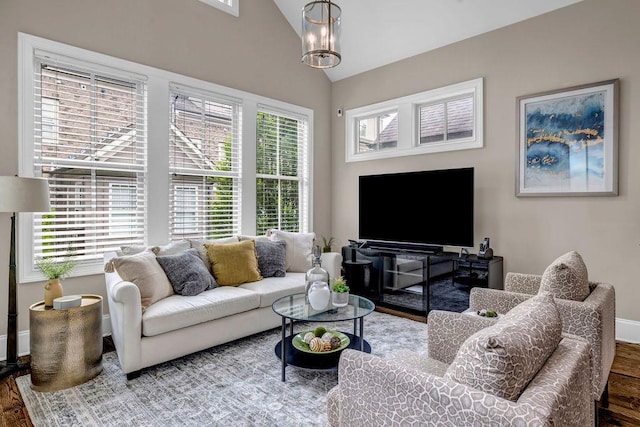 1120 Cordia Ave NW, Atlanta, GA 30318 - living room featuring wood finished floors, baseboards, vaulted ceiling, and a chandelier