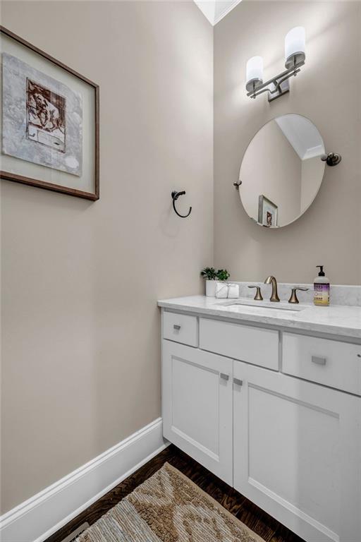 1120 Cordia Ave NW, Atlanta, GA 30318 - bathroom featuring vanity, wood finished floors, and baseboards